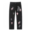 Chrome Hearts black denim jeans with pink and checkered cross patches
