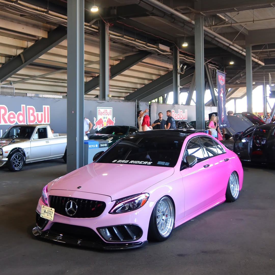 Professional installer applying pink gradient car wrap film