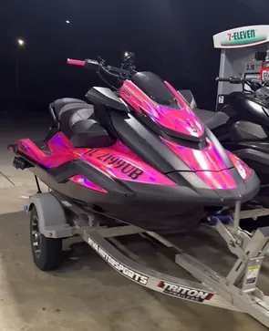boat wrapped with pink chrome car wrap