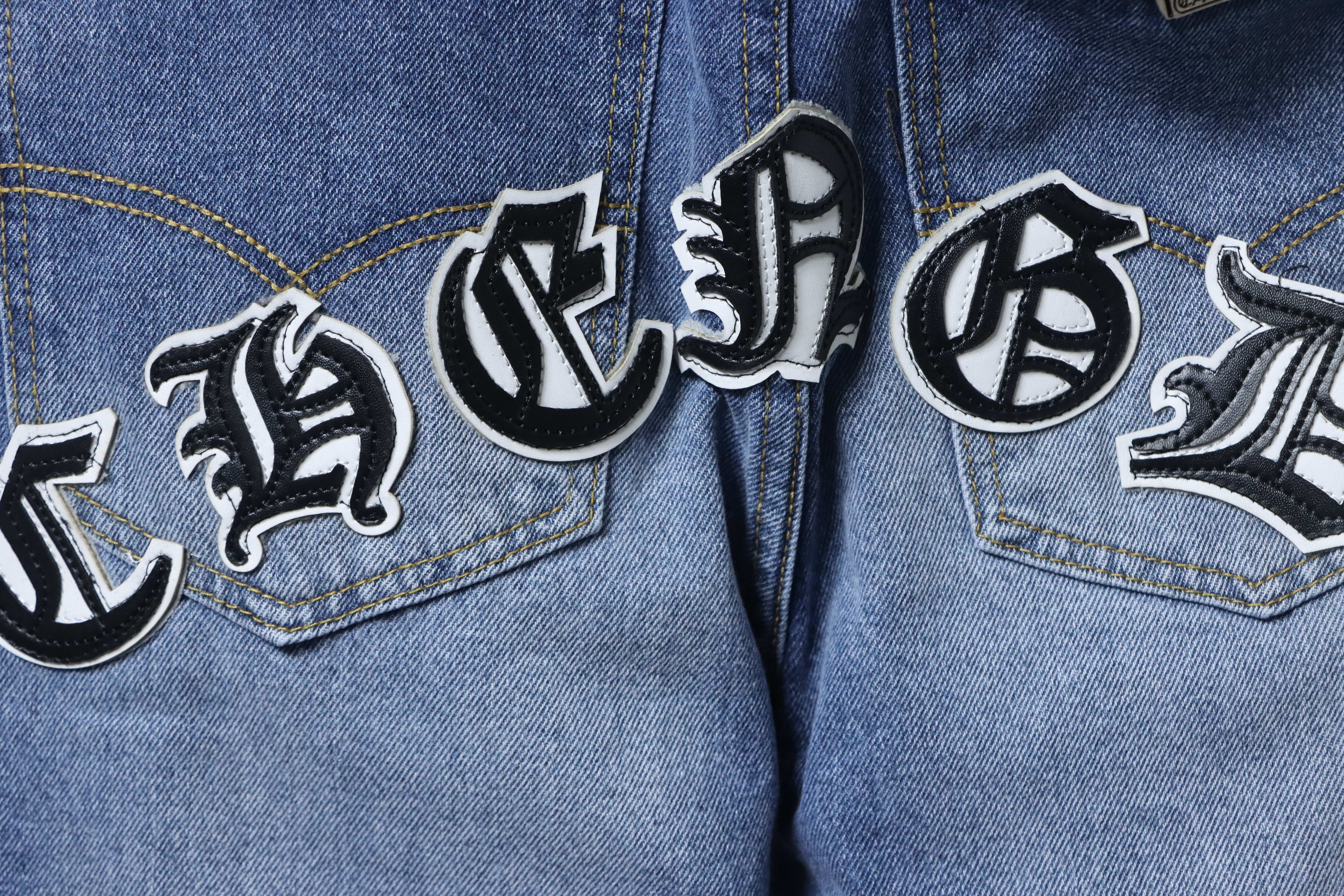 EM Sneakers Chrome Hearts Black and White Cross-patterned Jeans with Sanskrit on the Back