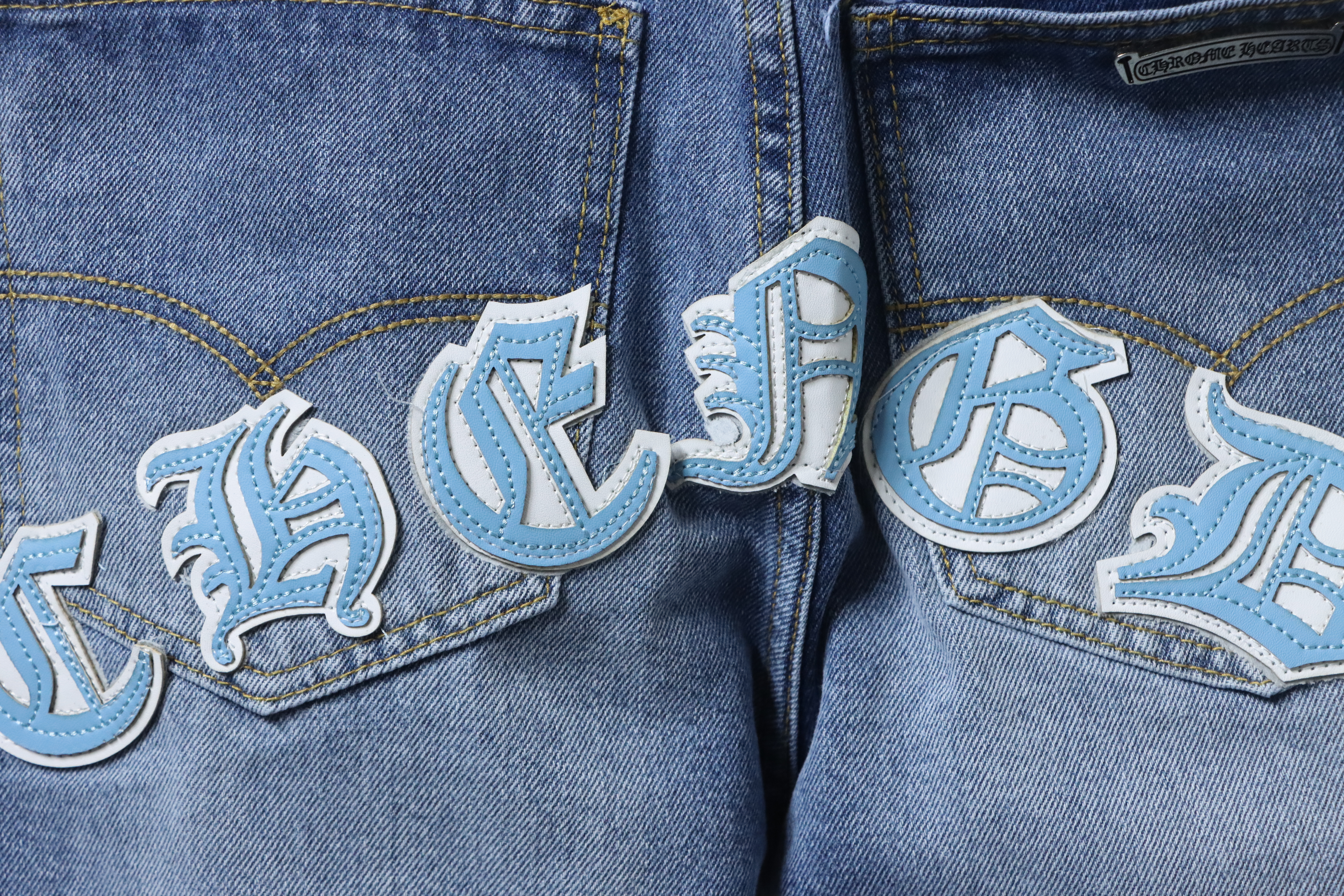 EM Sneakers Chrome Hearts Blue and White Cross-patterned Jeans with Sanskrit on the Back