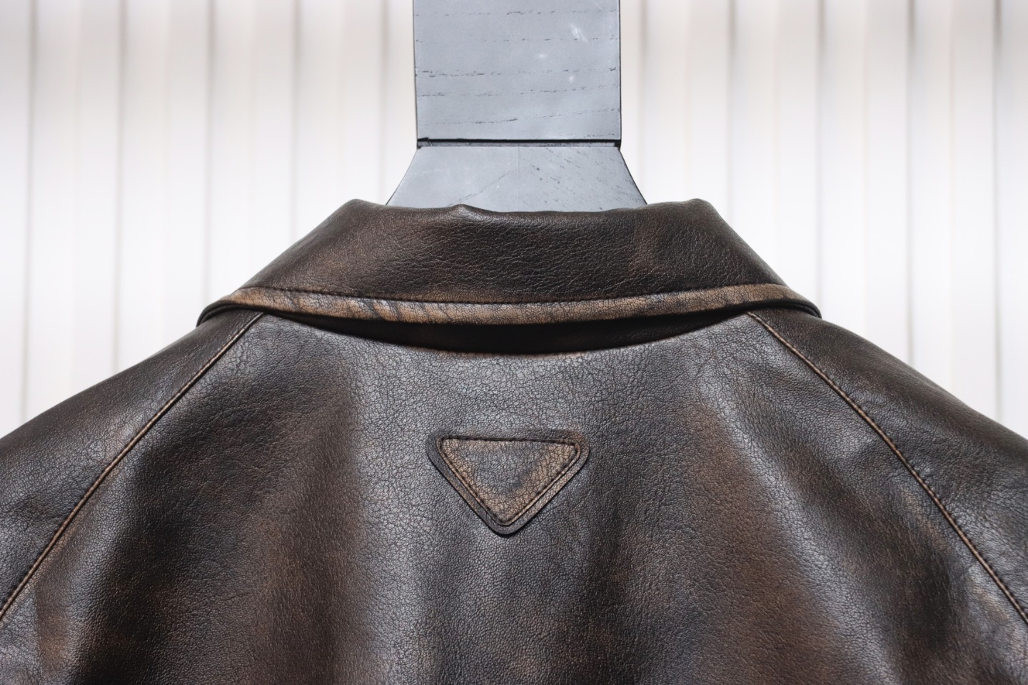 Prada Distressed Leather Jacket With Triangle Logo On Back