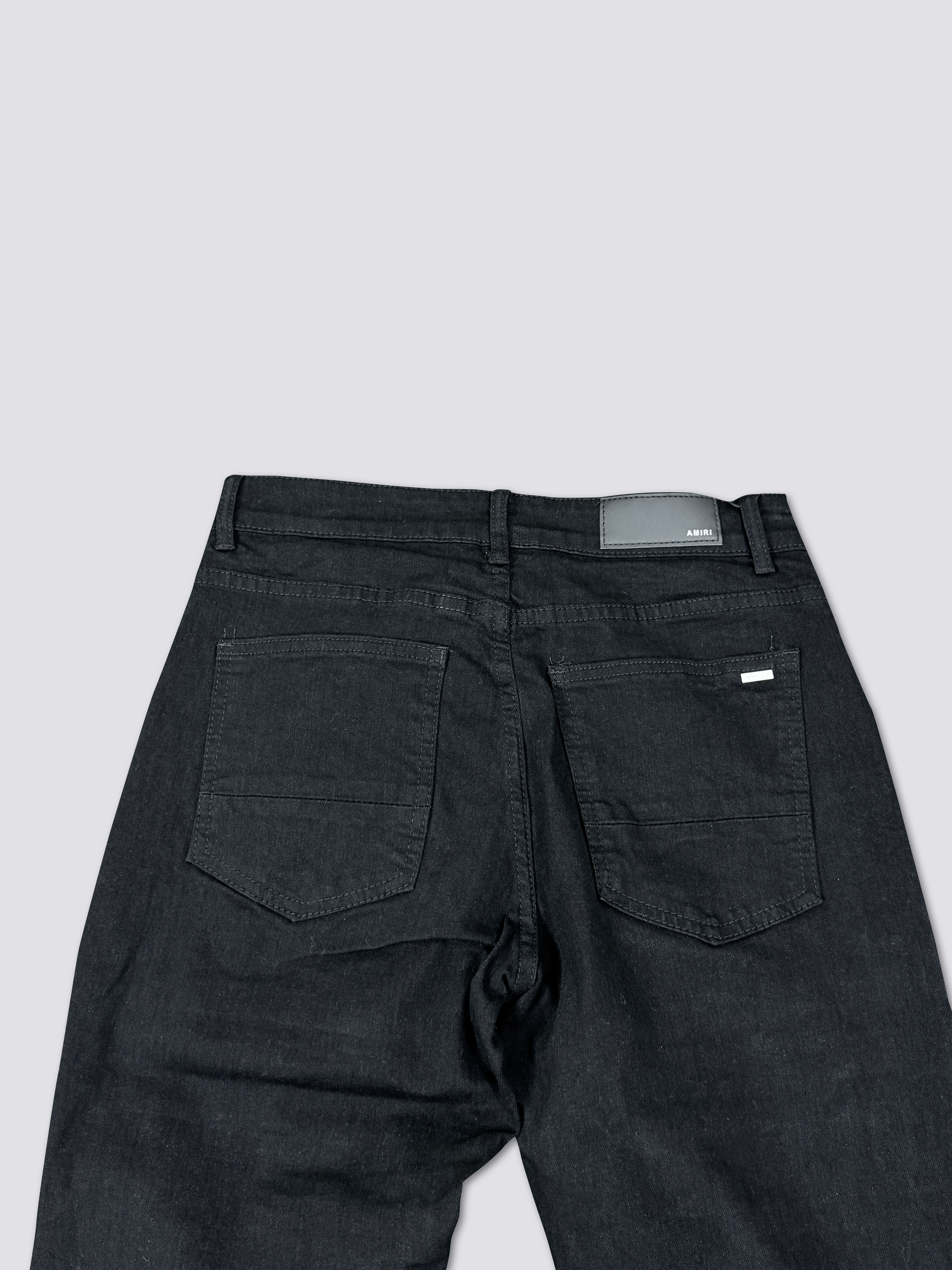 AMIRI washed denim with ink splatter and distressed details and silver rhinestone embellishments A011