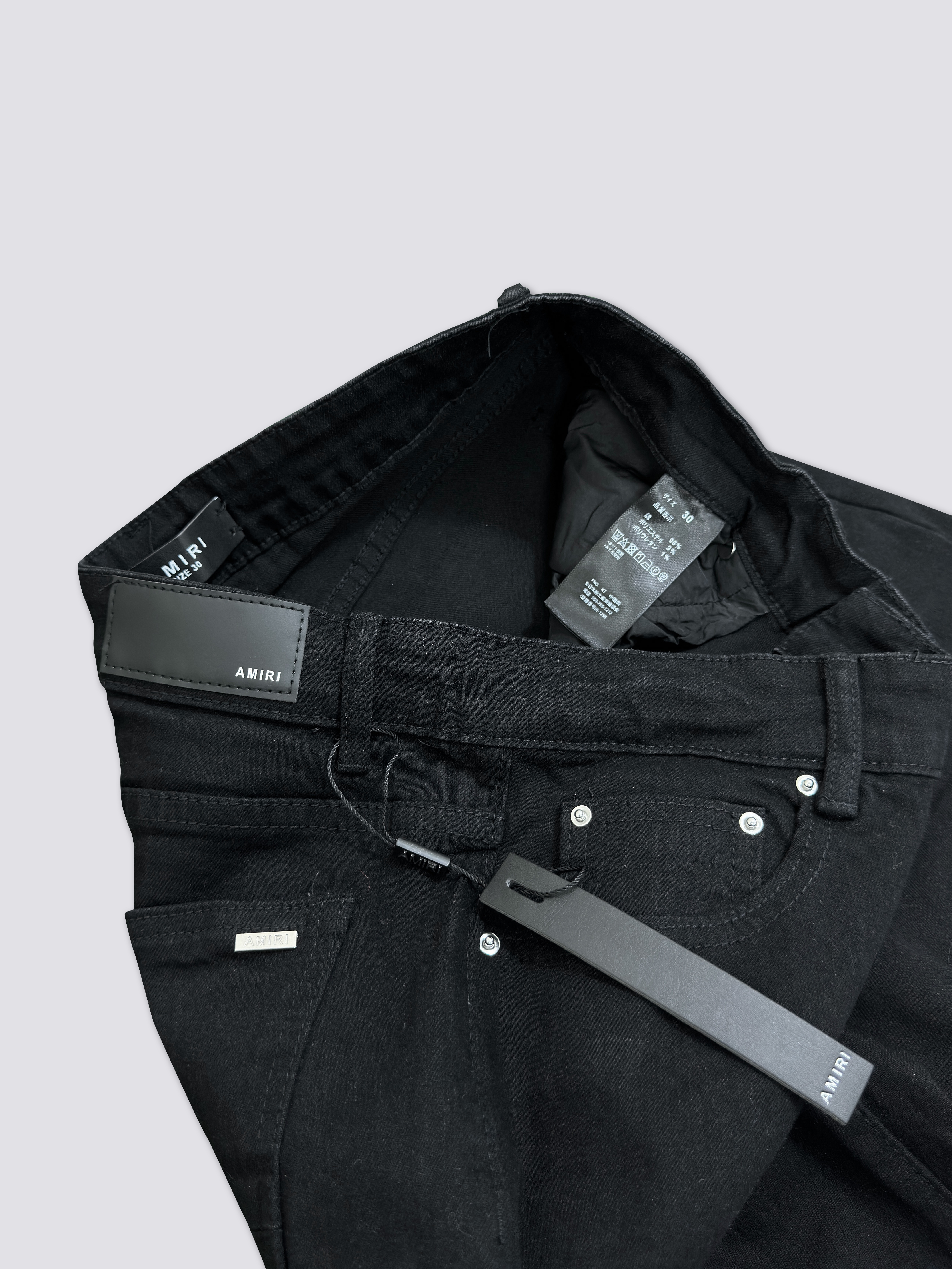 AMIRI washed denim with ink splatter and distressed details and silver rhinestone embellishments A011