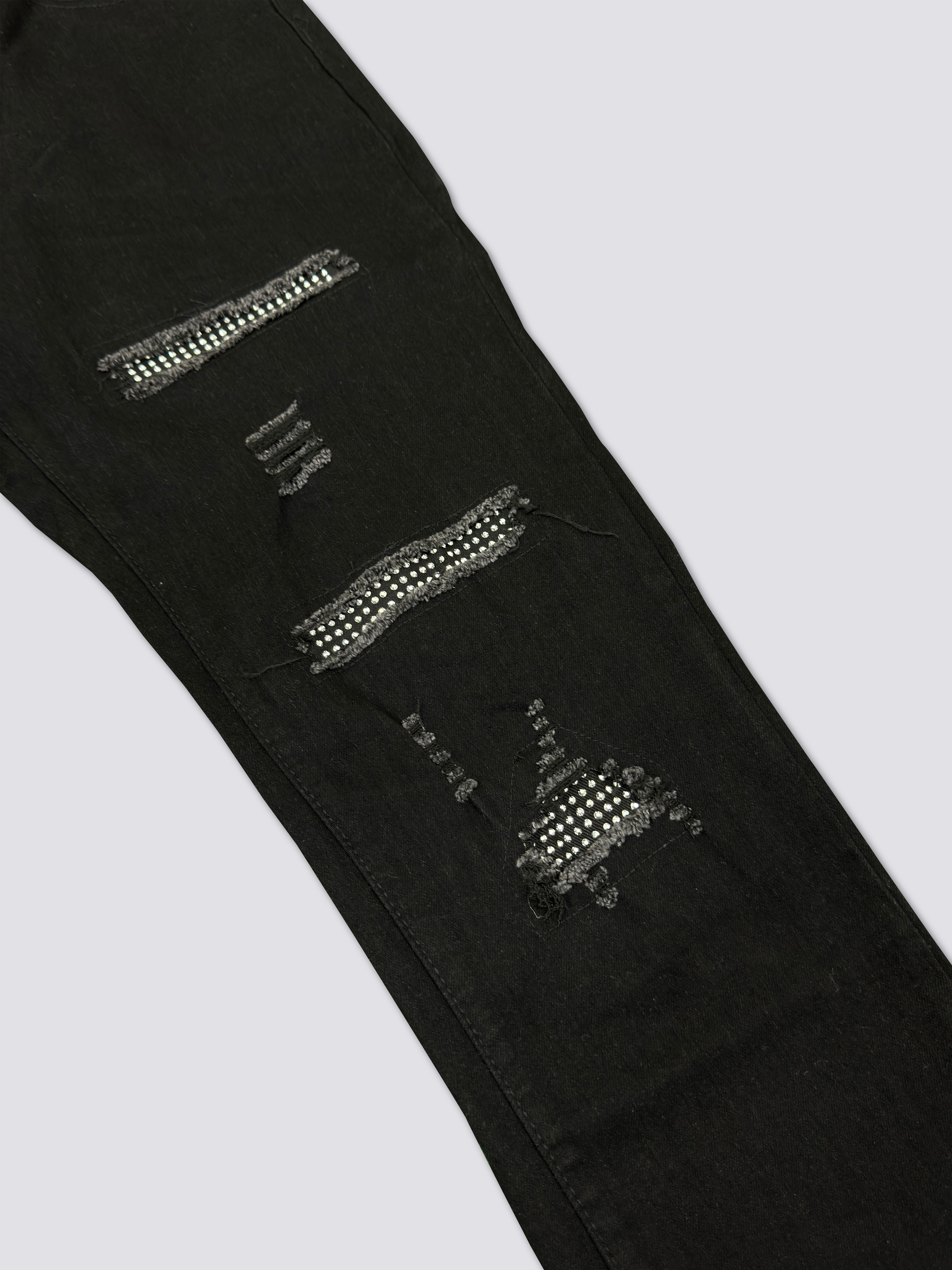 AMIRI washed denim with ink splatter and distressed details and silver rhinestone embellishments A011